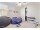 Cozy carpeted bedroom with a ceiling fan, beanbag chairs, a keyboard and closet with sliding doors at 3483 W Verde River Rd, San Tan Valley, AZ 85144