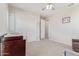 Neutral-toned bedroom featuring a closet, changing table, and a comfortable recliner at 3483 W Verde River Rd, San Tan Valley, AZ 85144