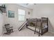 Bright bedroom with carpet, ceiling fan, bunk bed with slide and rocking chair at 3483 W Verde River Rd, San Tan Valley, AZ 85144