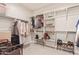 Walk-in closet with shelves and hanging racks providing ample storage space at 3483 W Verde River Rd, San Tan Valley, AZ 85144