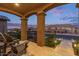 Inviting covered front porch with chairs and stone flooring, perfect for enjoying outdoor living at 3483 W Verde River Rd, San Tan Valley, AZ 85144