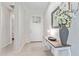 Bright hallway with a decorative table and a vase of flowers, leading to other areas of the home at 3483 W Verde River Rd, San Tan Valley, AZ 85144