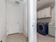 Well-lit laundry room with modern blue washer and dryer, plus storage cabinets at 3483 W Verde River Rd, San Tan Valley, AZ 85144