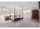 Spacious main bedroom with a four poster bed frame, ceiling fan, and natural light from the windows at 3483 W Verde River Rd, San Tan Valley, AZ 85144