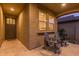 Back patio with two Adirondack chairs, textured stucco, and a welcoming covered entrance at 3483 W Verde River Rd, San Tan Valley, AZ 85144