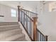 Carpeted stairs with wood railing offer stylish transition to upper levels at 3483 W Verde River Rd, San Tan Valley, AZ 85144