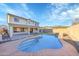 A backyard with a pool, waterfall, and a covered patio area at 3524 W Alyssa Ln, Phoenix, AZ 85083