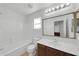 Bathroom with a tub and shower combination, brown cabinets, and white countertop at 3524 W Alyssa Ln, Phoenix, AZ 85083