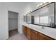 A modern bathroom with double sinks, a large mirror and a walk-in closet at 3524 W Alyssa Ln, Phoenix, AZ 85083