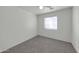 Bedroom featuring a large window providing natural light and neutral carpet at 3524 W Alyssa Ln, Phoenix, AZ 85083