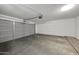 The garage is empty with a large garage door and a cement floor at 3524 W Alyssa Ln, Phoenix, AZ 85083