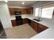 Kitchen boasts stainless steel refrigerator, black appliances, and ample cabinet space at 3524 W Alyssa Ln, Phoenix, AZ 85083