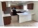 Bright kitchen features wood cabinets, a breakfast bar, and black appliances at 3524 W Alyssa Ln, Phoenix, AZ 85083
