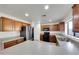 Well-lit kitchen with stainless steel refrigerator, wood cabinets, and white countertops at 3524 W Alyssa Ln, Phoenix, AZ 85083