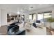 Bright living room area with views to backyard pool and open concept connection to kitchen and dining area at 3524 W Alyssa Ln, Phoenix, AZ 85083