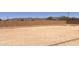 Spacious dirt backyard, great for customizable landscaping with mountain views behind brick wall at 3608 N Mansfield Dr, Litchfield Park, AZ 85340