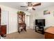 Bedroom with ceiling fan, desk and mounted television at 3608 N Mansfield Dr, Litchfield Park, AZ 85340