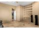 Bonus room with built-in shelves, light walls, and an open door to another room at 3608 N Mansfield Dr, Litchfield Park, AZ 85340