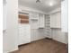 Spacious walk in closet with white shelving, drawers and hanging racks at 3608 N Mansfield Dr, Litchfield Park, AZ 85340