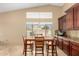 Bright dining area with a wood table set, large windows offering natural light, and dark wood trim at 3608 N Mansfield Dr, Litchfield Park, AZ 85340