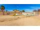 Enclosed dog run with a dog house and a grassy area. Chain link fence surrounds the area at 3608 N Mansfield Dr, Litchfield Park, AZ 85340