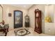 Elegant foyer featuring a decorative iron door, grandfather clock, and marble flooring at 3608 N Mansfield Dr, Litchfield Park, AZ 85340