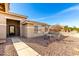 Charming home exterior with a wrought iron front door and cozy outdoor seating area at 3608 N Mansfield Dr, Litchfield Park, AZ 85340