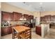 Well-equipped kitchen with granite countertops, stainless steel appliances, wood cabinetry and adjacent dining area at 3608 N Mansfield Dr, Litchfield Park, AZ 85340