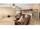 Open-concept living room featuring a large sectional sofa, tile floors, and seamless transition to the kitchen at 3608 N Mansfield Dr, Litchfield Park, AZ 85340