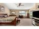 Large main bedroom with a spacious layout, ceiling fan, and natural light from several windows at 3608 N Mansfield Dr, Litchfield Park, AZ 85340