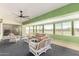 Enclosed patio with green trim features bright furniture, a fan, and views of the outside at 3608 N Mansfield Dr, Litchfield Park, AZ 85340