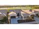 Expansive aerial view of a single Gathering home on a golf course with lake views at 36276 N Secret Garden Path, Queen Creek, AZ 85140