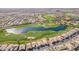 Stunning aerial view of a luxury community featuring a lush golf course and serene lake at 36276 N Secret Garden Path, Queen Creek, AZ 85140