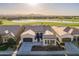 Picturesque aerial shot of a single-Gathering home with golf course frontage, lake view, and desert mountains backdrop at 36276 N Secret Garden Path, Queen Creek, AZ 85140