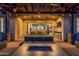 Inviting outdoor seating area with a fire pit, ceiling fans, and dining set visible through the sliding doors at 36276 N Secret Garden Path, Queen Creek, AZ 85140