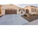 Charming single-story home featuring a well-manicured lawn, desert landscaping, and a spacious three-car garage at 36276 N Secret Garden Path, Queen Creek, AZ 85140