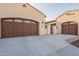 Spacious three-car garage with large driveway and secure gated entry to the charming single-story home at 36276 N Secret Garden Path, Queen Creek, AZ 85140