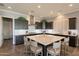 Modern kitchen with dark cabinets, a large island, and plenty of counter space for cooking and entertaining at 36276 N Secret Garden Path, Queen Creek, AZ 85140