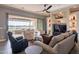 Bright living room featuring a large sliding glass door to the patio with lake views at 36276 N Secret Garden Path, Queen Creek, AZ 85140