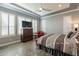 Inviting main bedroom features plantation shutters, tray ceiling, and tile floors, offering a blend of style and comfort at 36276 N Secret Garden Path, Queen Creek, AZ 85140