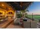 Expansive outdoor living area features a fire pit, outdoor kitchen, and a covered patio at 36276 N Secret Garden Path, Queen Creek, AZ 85140