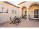 Charming patio with desert decor, outdoor seating, and arched entrance offers a serene and private retreat at 36276 N Secret Garden Path, Queen Creek, AZ 85140