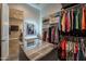 Well-organized walk-in closet featuring custom shelves, hanging racks, and marble-topped island with drawers at 36276 N Secret Garden Path, Queen Creek, AZ 85140