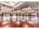 Expansive ballroom with hardwood floors, decorative lighting, and multiple entrances to outdoor areas at 3792 E Westchester Dr, Chandler, AZ 85249