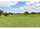 Expansive view of a meticulously maintained golf course with sand traps and lush trees at 3792 E Westchester Dr, Chandler, AZ 85249