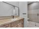 Modern bathroom features a stylish wood vanity, decorative mirror, and glass shower at 38024 N 15Th Ave, Phoenix, AZ 85086