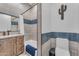 Stylish bathroom with a wood vanity, tiled tub surround, and modern fixtures at 38024 N 15Th Ave, Phoenix, AZ 85086