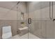 Sleek bathroom features a modern glass shower with built-in seating and tiled walls at 38024 N 15Th Ave, Phoenix, AZ 85086