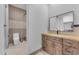 Modern bathroom featuring rustic wood vanity, stylish mirror, and tiled shower at 38024 N 15Th Ave, Phoenix, AZ 85086