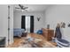 Stylish bedroom with wood floors, a ceiling fan, and a large window at 38024 N 15Th Ave, Phoenix, AZ 85086